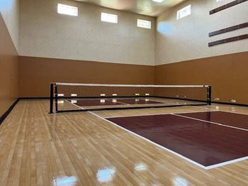 a tennis court in a room with a net